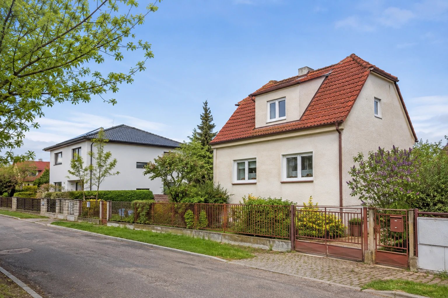 Älteres und neueres Familienhaus mit Gärten an einer ruhigen Wohnstraße in Hostivice